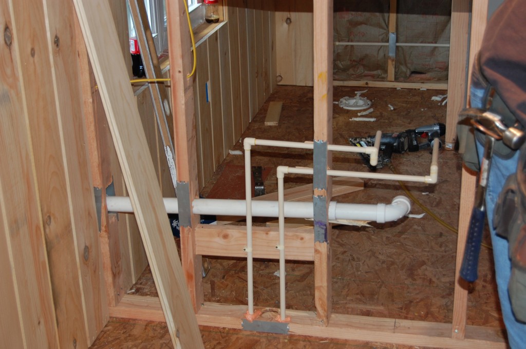 Plumbing the bathroom. I know this seems a little extravagant for a shop, but it's necessary - I have pretty much detroyed the downstairs bathroom in the house. The white toilet has rusted from the steel dust that shakes off my pants...